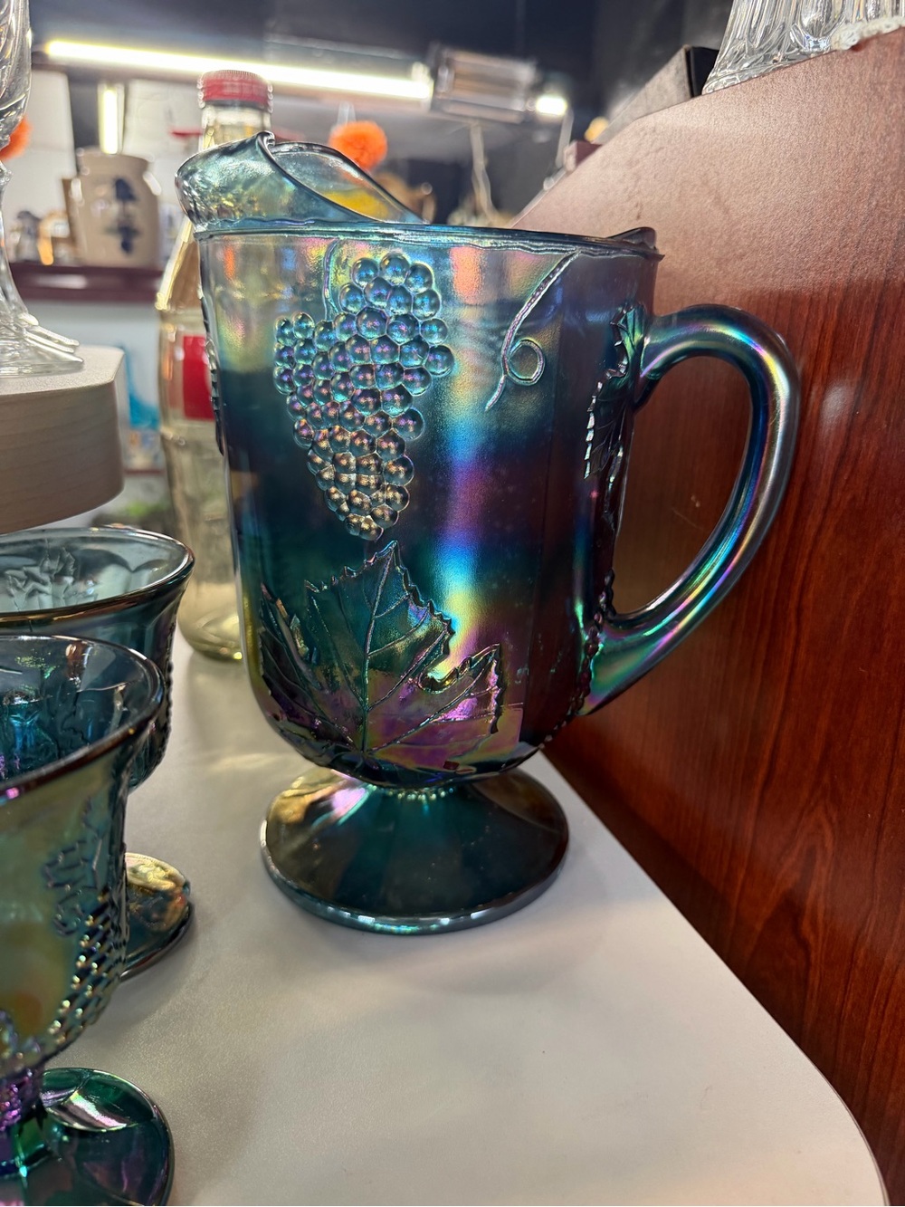 Iridescent Blue-Green Carnival Glass Pitcher with Grape Motif